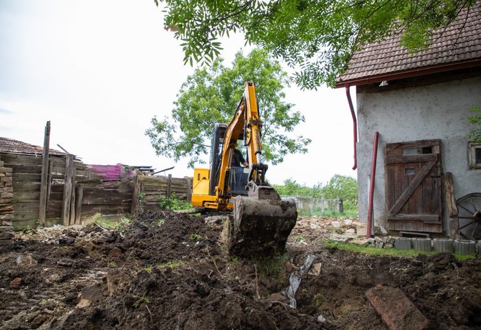 Excavator preparing and grading a construction site