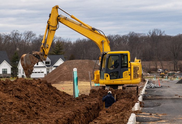 Excavator digging a utility trench